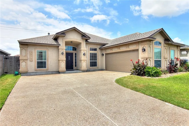 a front view of a house with a yard and garage