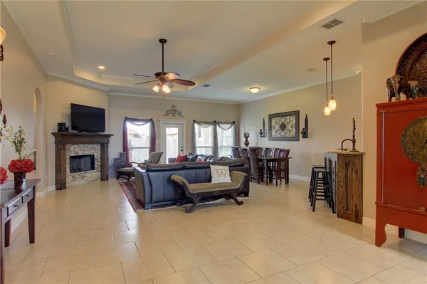 a living room with furniture a fireplace and a flat screen tv