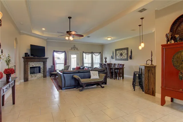 a living room with furniture a fireplace and a flat screen tv