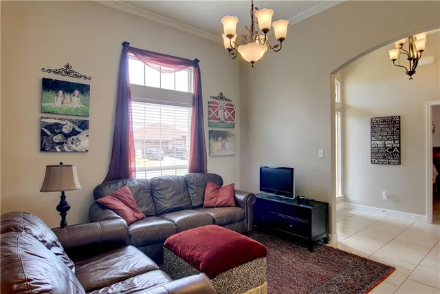 a living room with furniture a flat screen tv and a window