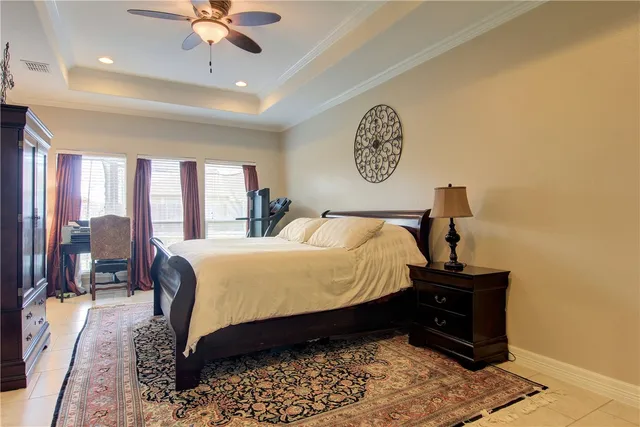 a bed sitting in a spacious bedroom next to a window