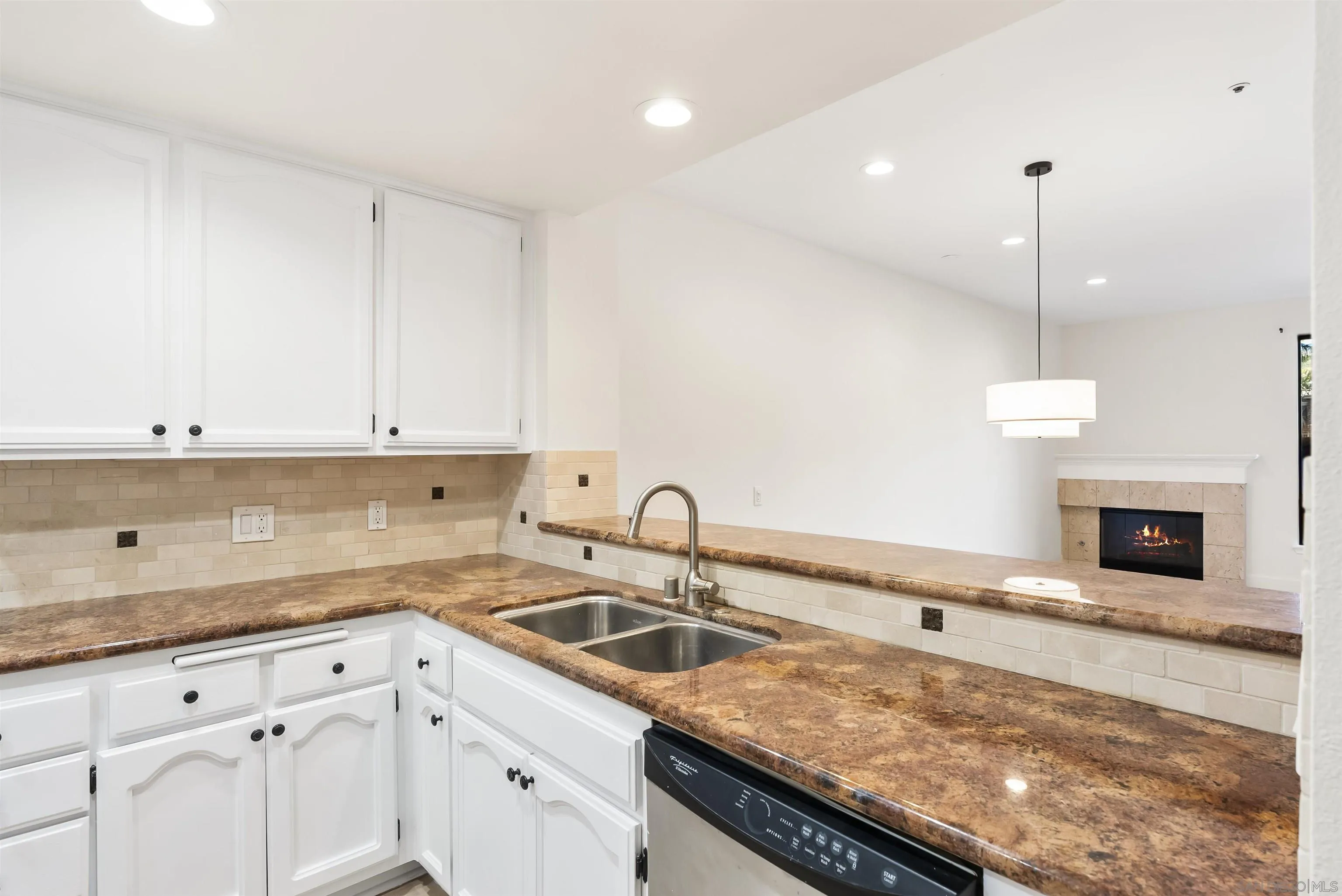 5805 Friars Road, Unit 2115 San Diego, CA 92110 - Photo 5 of 16 a kitchen with granite countertop a sink a stove and cabinets