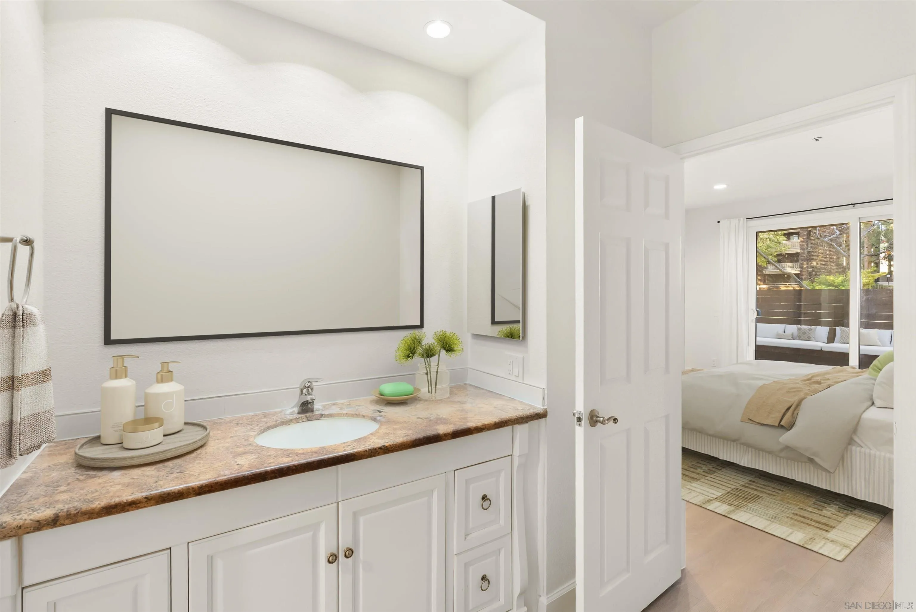 5805 Friars Road, Unit 2115 San Diego, CA 92110 - Photo 7 of 16 a en suite bathroom with a granite countertop sink and a mirror