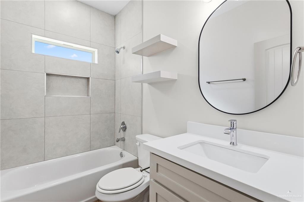 2102 Trinity Street Donna, TX 78537 - Photo 15 of 24 a bathroom with a sink a toilet and a mirror