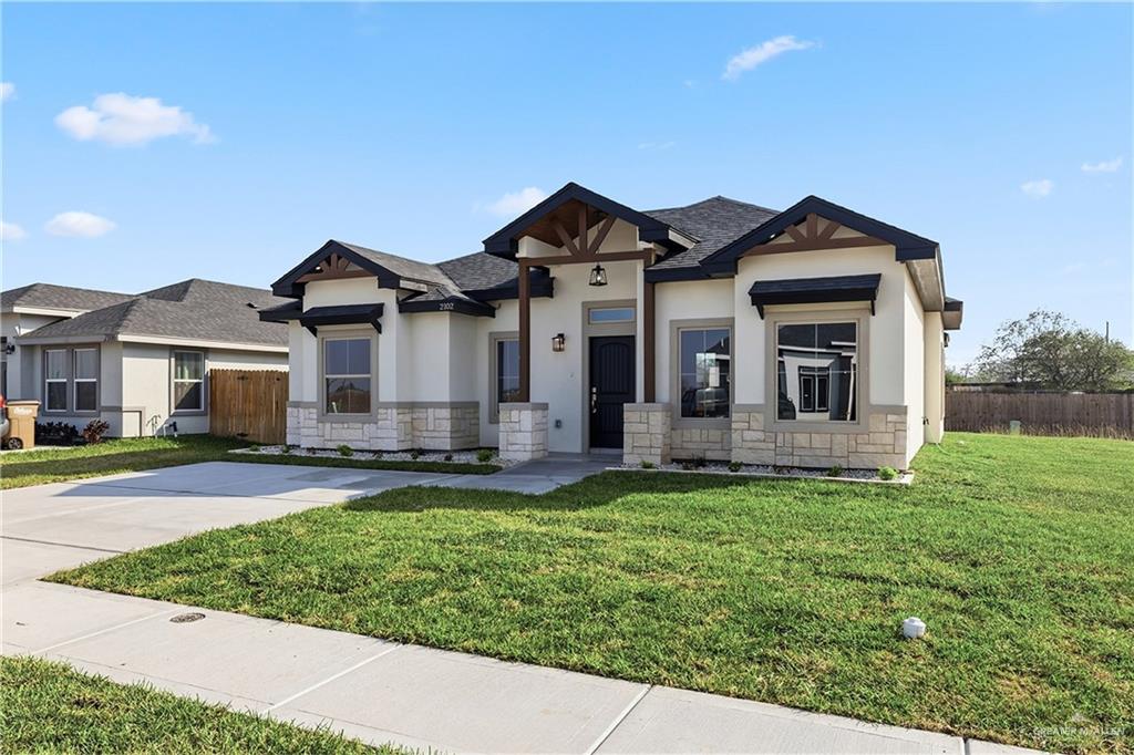 2102 Trinity Street Donna, TX 78537 - Photo 3 of 24 a front view of a house with a yard
