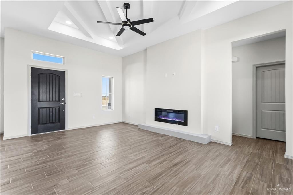 2102 Trinity Street Donna, TX 78537 - Photo 4 of 24 a view of a livingroom with wooden floor and a ceiling fan