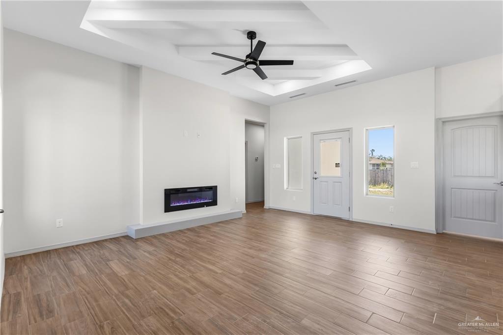 2102 Trinity Street Donna, TX 78537 - Photo 5 of 24 a view of empty room with wooden floor and ceiling fan