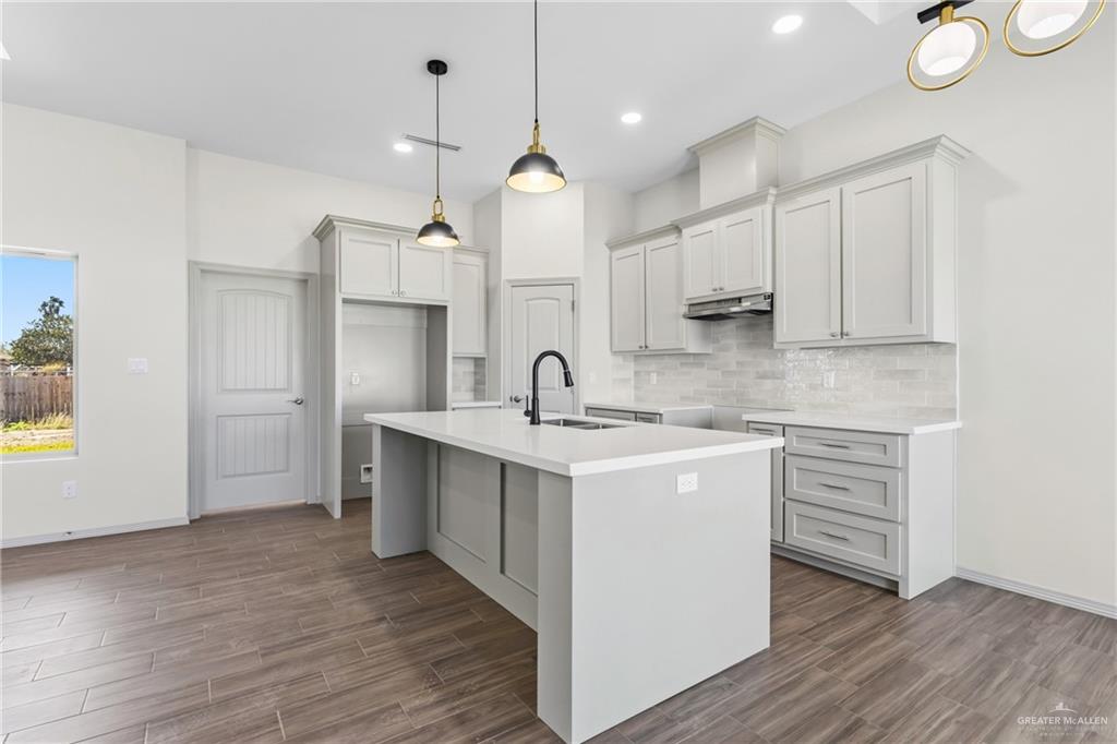 2102 Trinity Street Donna, TX 78537 - Photo 7 of 24 a kitchen with stainless steel appliances granite countertop a sink stove and refrigerator
