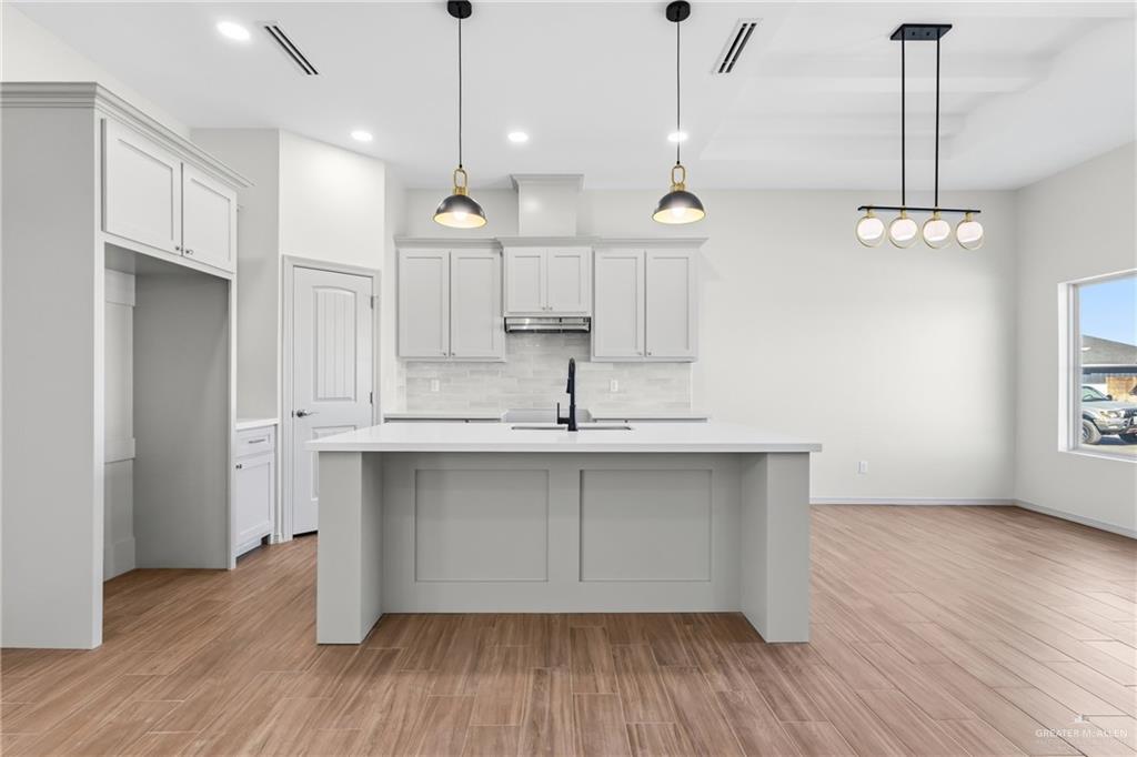 2102 Trinity Street Donna, TX 78537 - Photo 9 of 24 a view of a kitchen with a sink a window and wooden floor
