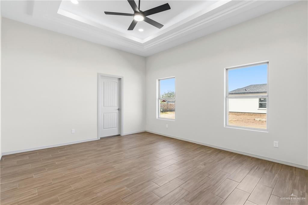 2102 Trinity Street Donna, TX 78537 - Photo 10 of 24 wooden floor in an empty room with a window
