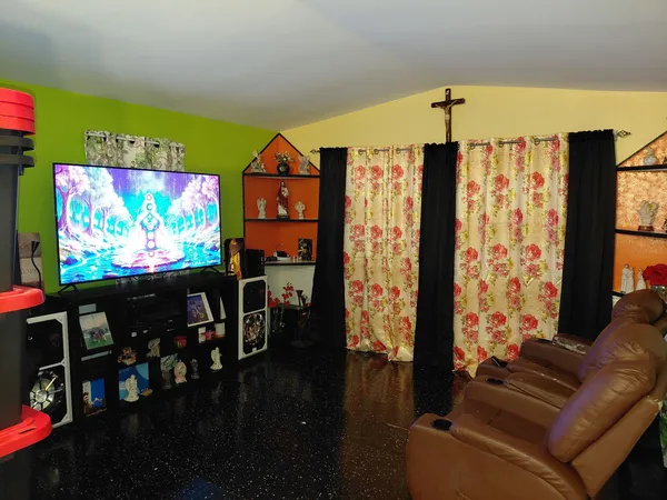 a living room with furniture and a flat screen tv