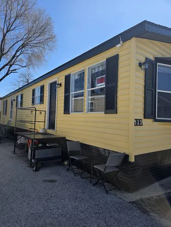 a backyard of a house with yard and wooden fence