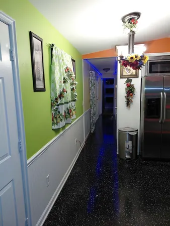 a view of a hallway with furniture and chandelier