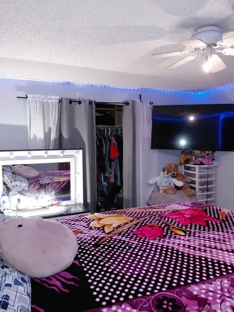 a bedroom with furniture and a flat screen tv