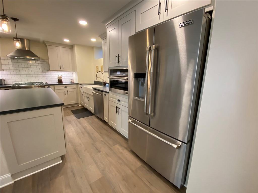 2300 Beallsville Road Marianna, PA 15345 - Photo 5 of 25 a kitchen with stainless steel appliances a refrigerator a sink and white cabinets