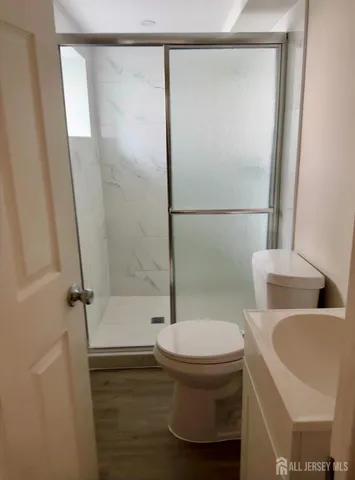 a bathroom with a toilet and a shower
