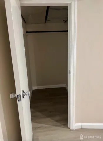 a view of walk in closet with empty racks