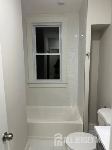 a bathroom with a toilet and a bathtub