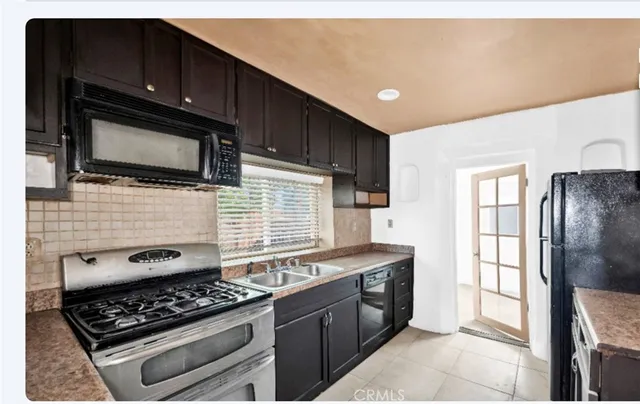 a kitchen with stainless steel appliances granite countertop a stove and a microwave