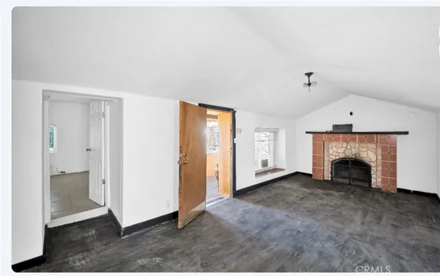 an empty room with fireplace