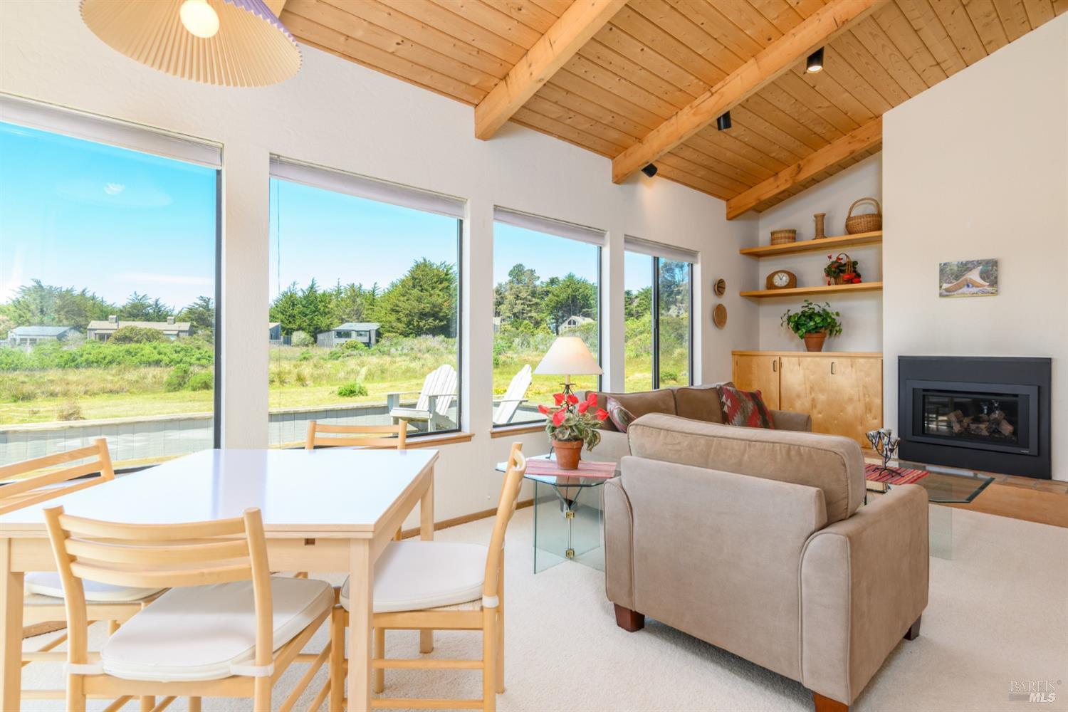 267 Sea Stack The Sea Ranch, CA 95497 - Photo 19 of 35 a living room with fireplace furniture and a large window