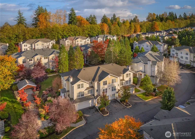 an aerial view of residential houses with outdoor space