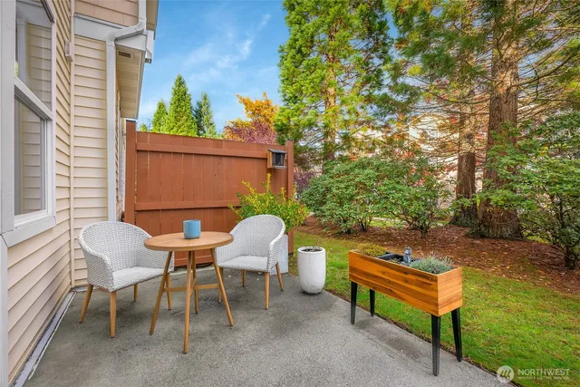 a backyard of a house with table and chairs