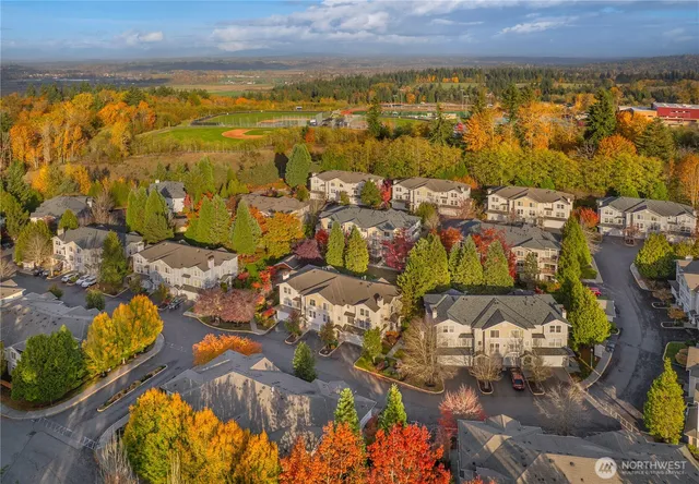 an aerial view of residential houses with outdoor space