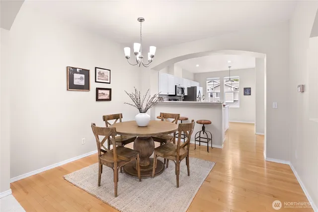 a view of a dining room with furniture and chandelier