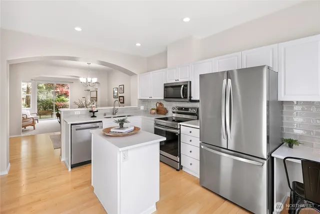 a kitchen with stainless steel appliances a refrigerator stove microwave and sink