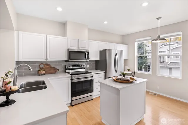 a kitchen with sink a stove and refrigerator