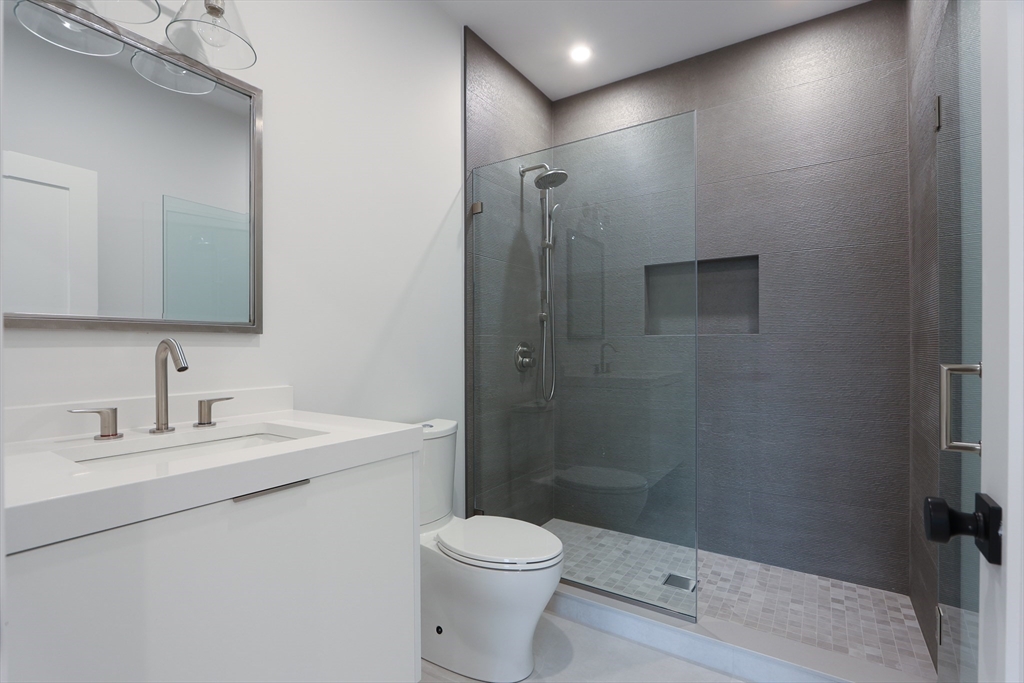 189 Hartman Road Newton, MA 02459 - Photo 16 of 38 a bathroom with a sink a toilet and shower