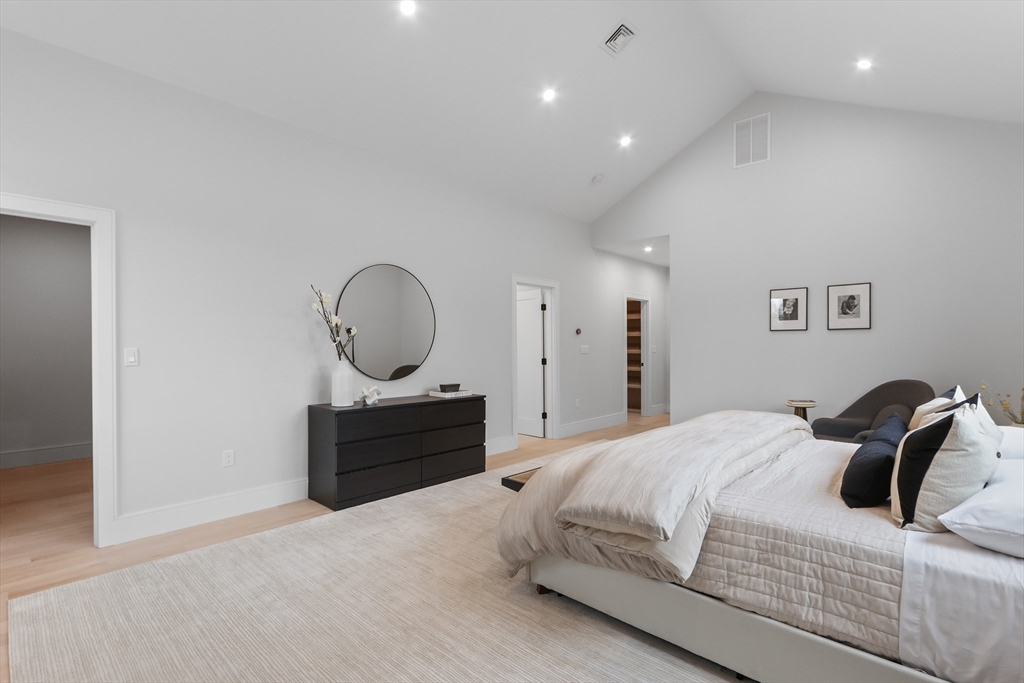 189 Hartman Road Newton, MA 02459 - Photo 21 of 38 a bedroom with a bed a mirror and dresser