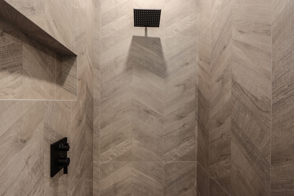 189 Hartman Road Newton, MA 02459 - Photo 25 of 38 a bathroom with a shower and a window