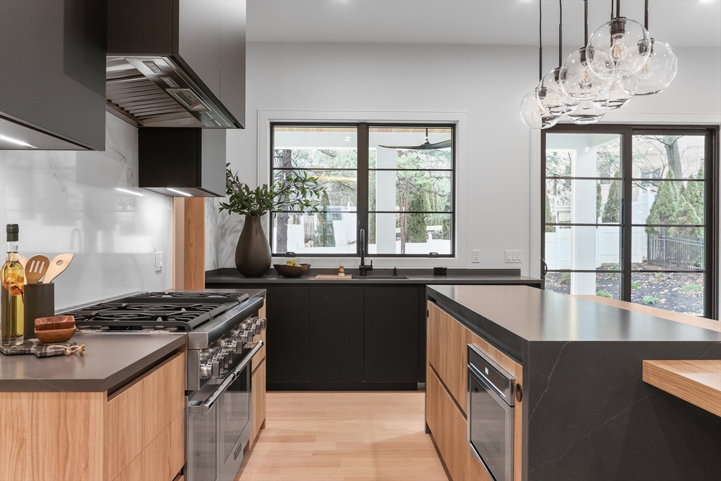 189 Hartman Road Newton, MA 02459 - Photo 3 of 38 a kitchen with granite countertop a stove and a sink