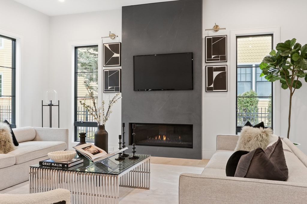 189 Hartman Road Newton, MA 02459 - Photo 7 of 38 a living room with furniture a flat screen tv and a fireplace