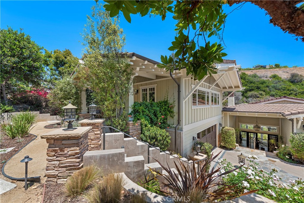 a view of a patio with couches table and chairs and potted plants