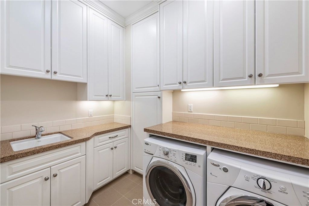 1339 Dunning Drive Laguna Beach, CA 92651 - Photo 16 of 42 a kitchen with granite countertop white cabinets and sink