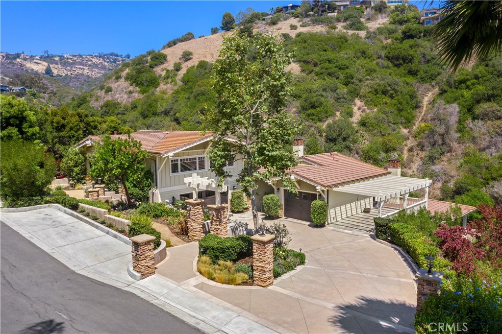 1339 Dunning Drive Laguna Beach, CA 92651 - Photo 3 of 42 a house with lots of trees in the background