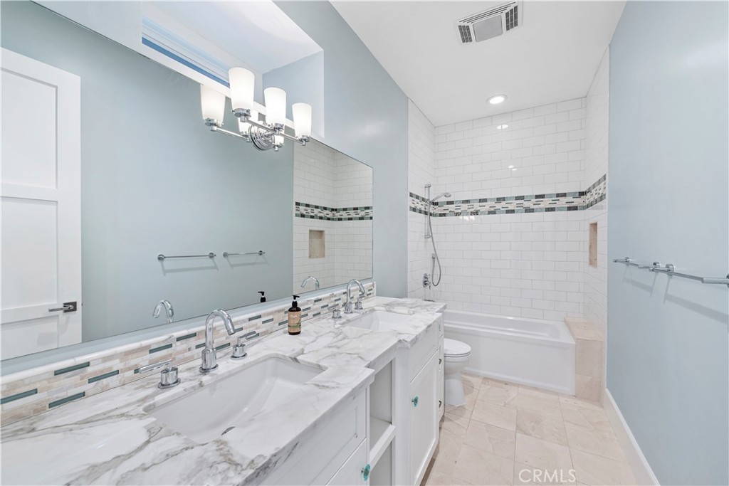 1339 Dunning Drive Laguna Beach, CA 92651 - Photo 32 of 42 a bathroom with a sink a toilet and a mirror