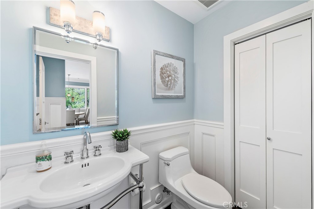 1339 Dunning Drive Laguna Beach, CA 92651 - Photo 33 of 42 a bathroom with a toilet a sink and a mirror