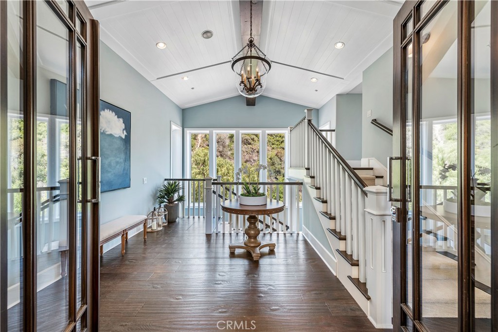 1339 Dunning Drive Laguna Beach, CA 92651 - Photo 6 of 42 a view of a hallway with wooden floor windows and a chandelier