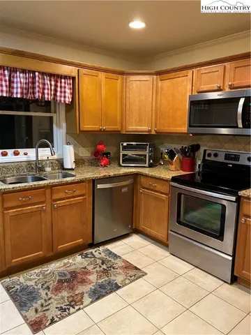 a kitchen with a stove sink and microwave