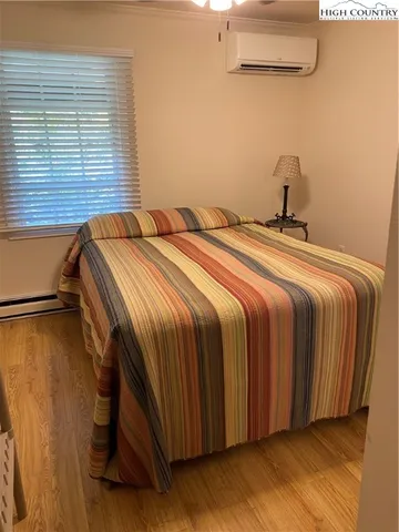 a bedroom with a bed and a night stand