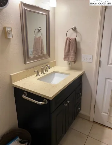 a bathroom with a sink vanity and mirror