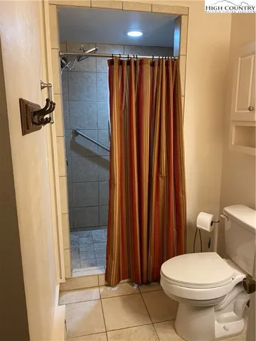 a bathroom with a toilet and a shower