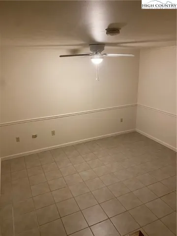 a living room with furniture and a lamp