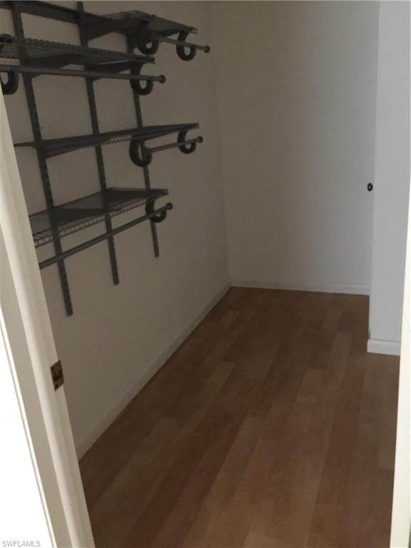 5651 Rattlesnake Hammock Road, Unit C108 Naples, FL 34113 - Photo 12 of 14 wooden floor in an empty room