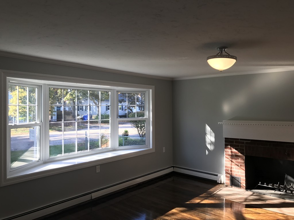 20 Selwyn Road Randolph, MA 02368 - Photo 4 of 20 a view of an empty room with wooden floor and a window