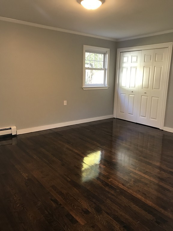 20 Selwyn Road Randolph, MA 02368 - Photo 8 of 20 an empty room with wooden floor and windows